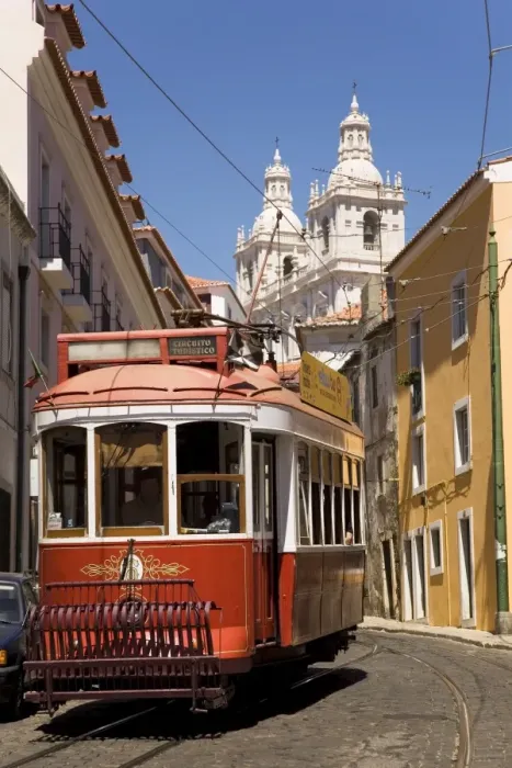 Framed Print : A tram runs along the tourist friendly Number 28 route in Alfama, Lisbon Framed Print : A tram runs along the tourist friendly Number 28 route in Alfama, Lisbon