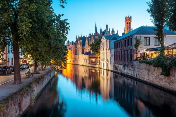 Framed Print : A tranquil canal scene in Bruges, with the spires of the Stadhuis (Town Hall) in
