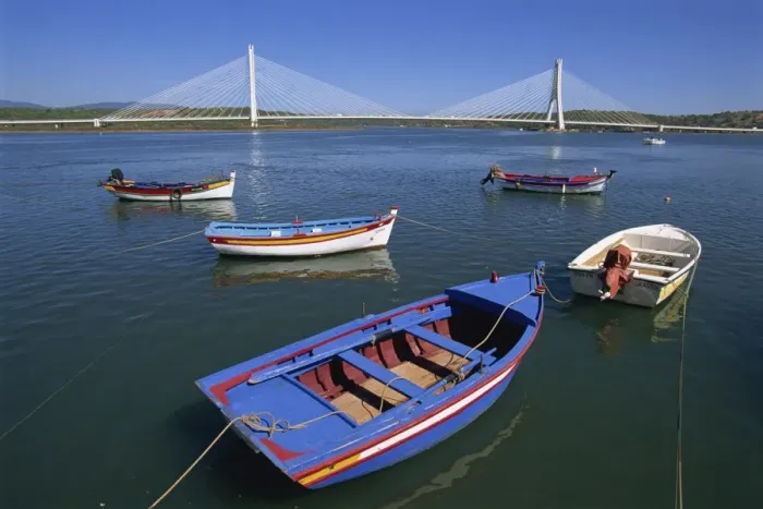 Framed Print : Tranquil scene of fishing boats and suspension bridge Framed Print : Tranquil scene of fishing boats and suspension bridge