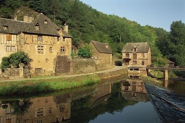 Tranquil scene of reflections in water of a millhouse near Conques, Aveyron