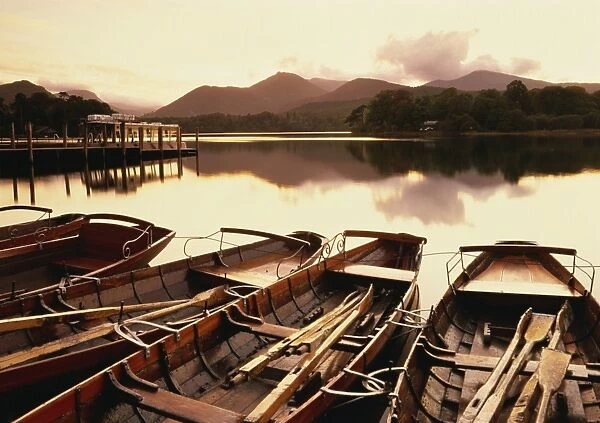 Tranquil scene at sunset over Derwentwater and Derwent Isle with pleasure boats