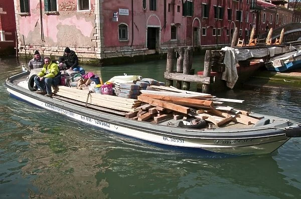 Transporting goods by boat on canal, Venice, Veneto, Italy, Europe