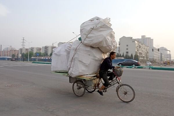 Transporting a precarious load through Beijing, China, Asia
