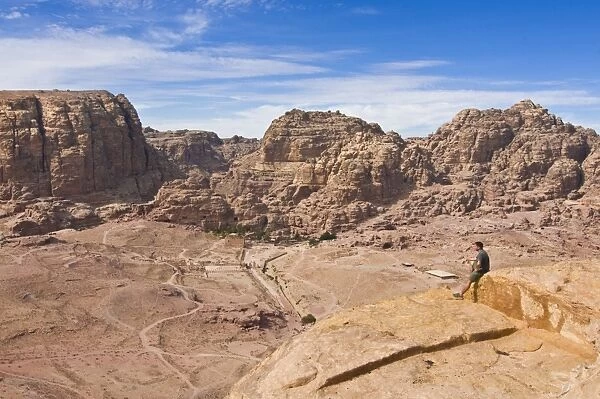 Traveller enjoying the view over Petra, UNESCO World Heritage Site, Jordan, Middle East