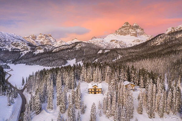 Tre Cime di Lavaredo and woods covered with snow during a winter sunset, Misurina