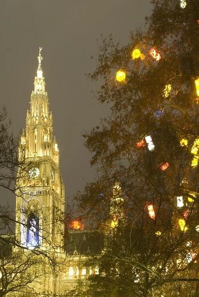 Tree decorated with lit Christmas presents and Rathaus (Town Hall) tower at Rathausplatz at twilight, Innere Stadt, Vienna
