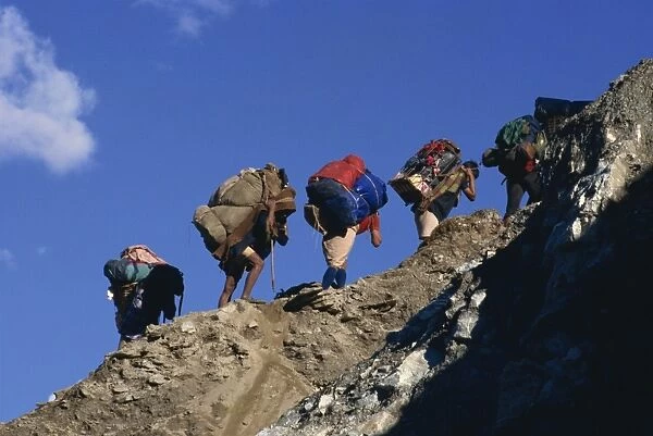 Trek porters on eroded trail to Ghorapani Pass near Chitre, Nepal, Asia