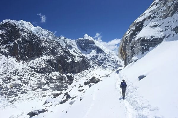 Trekker walking over Cho La Pass with Lobuche West and East on left side, Solukhumbu District, Nepal, Himalayas, Asia