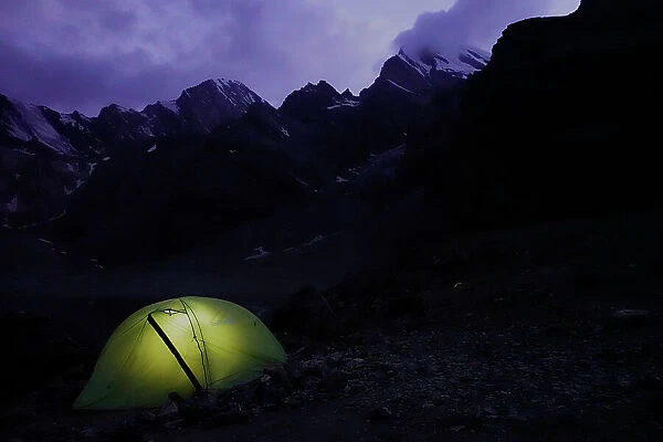 Trekker's tent lit inside at night in the remote and spectacular Fann Mountains, part of the western Pamir-Alay, Tajikistan, Central Asia, Asia