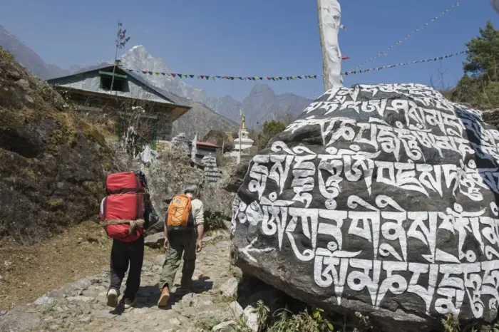 Framed Print : Trekkers walking past a mani stone, Solu Khumbu Everest Region, Sagarmatha National Park Framed Print : Trekkers walking past a mani stone, Solu Khumbu Everest Region, Sagarmatha National Park