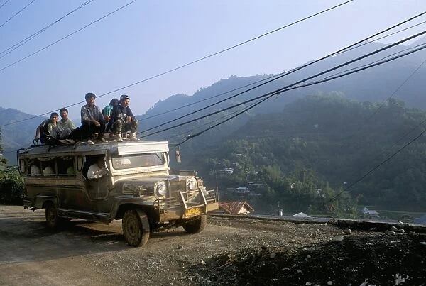 Truck carrying passengers on the roof