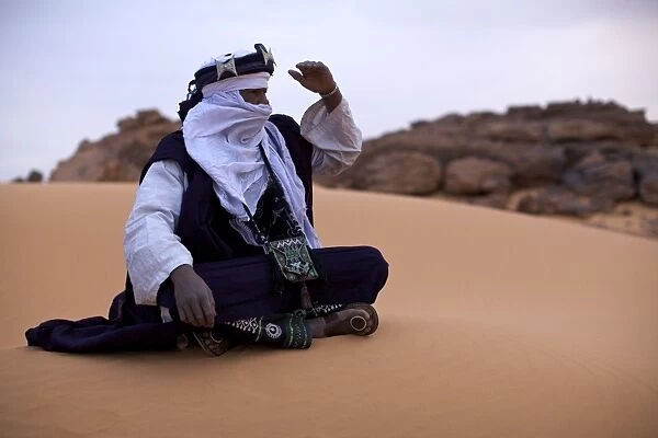 A Tuareg dressed for celebrations at the entrance of the Dar Sahara tented camp in the Fezzan desert, Libya, North