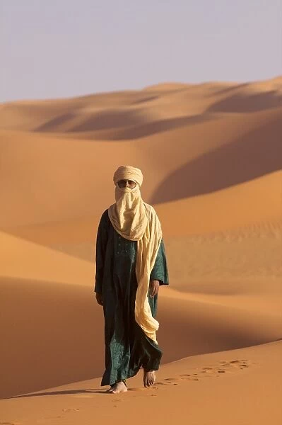 A Tuareg on the dunes of the erg of Murzuk in the Fezzan desert, Libya