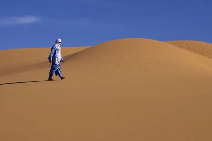Framed Print : A Tuareg walking on a dune of the erg of Uan Kaza in the Fezzan desert Framed Print : A Tuareg walking on a dune of the erg of Uan Kaza in the Fezzan desert