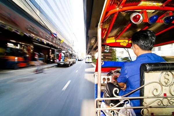 Tuk tuk driver speeding in Bangkok, Thailand, Southeast Asia, Asia