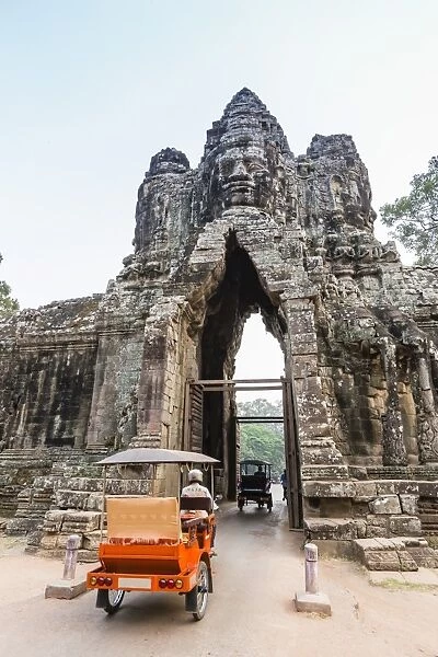 Tuk-tuks driving through the South Gate at Angkor Thom, Angkor, UNESCO World Heritage Site, Siem Reap Province, Cambodia, Indochina, Southeast Asia, Asia