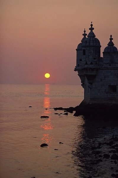 Turrets of the 16th century Belem Tower silhouetted in the sunset