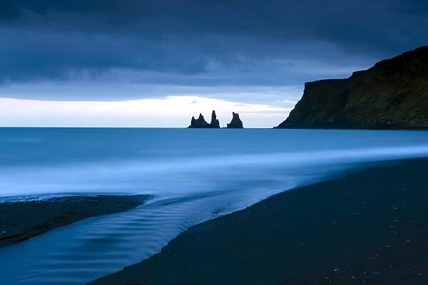 Twilight view towards rock stacks at Reynisdrangar off the coast at Vik