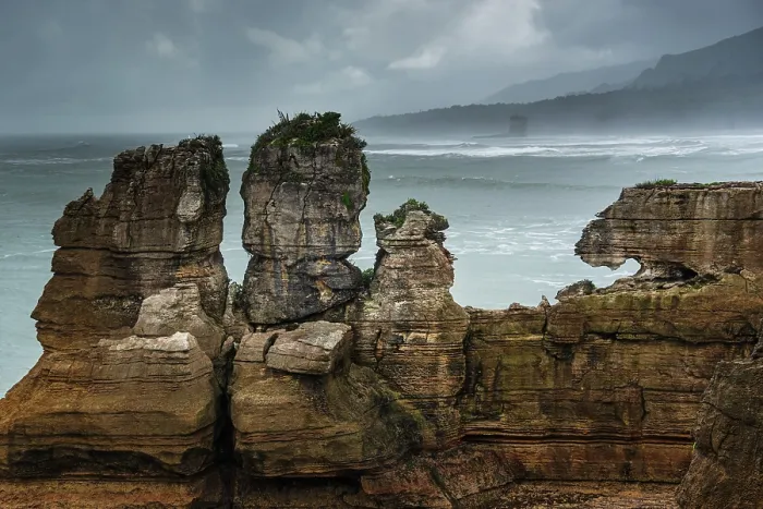 Framed Print : Twin Rock Formations at Pancake Rocks Against a Moody Sky in Punakaiki, Paparoa National Park, New Zealand Framed Print : Twin Rock Formations at Pancake Rocks Against a Moody Sky in Punakaiki, Paparoa National Park, New Zealand