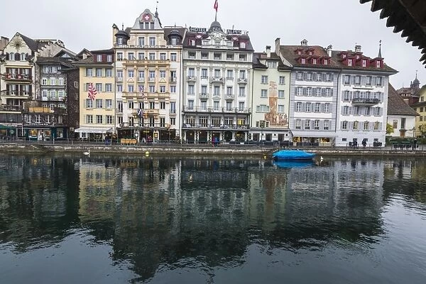 The typical buildings of the old medieval town are reflected in River Reuss, Lucerne
