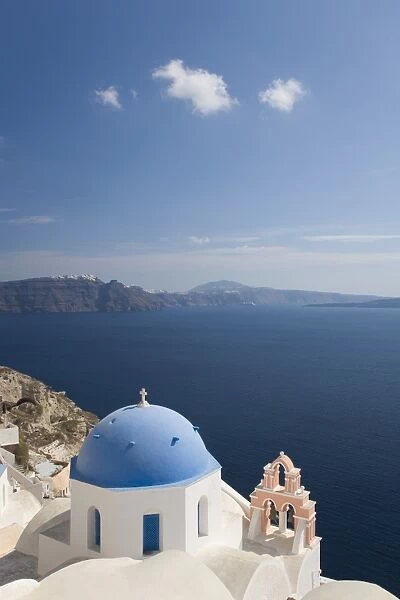 Typical church clinging to hillside above the Aegean Sea, Oia (Ia), Santorini (Thira) (Thera), Cyclades Islands, Greek Islands, Greece, Europe