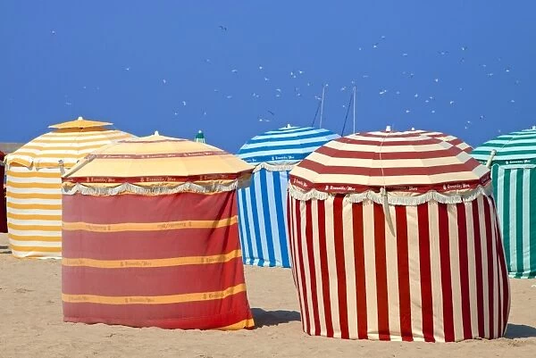 Typical color striped beach cabins, beach and sea, Trouville sur Mer, Normandy, France