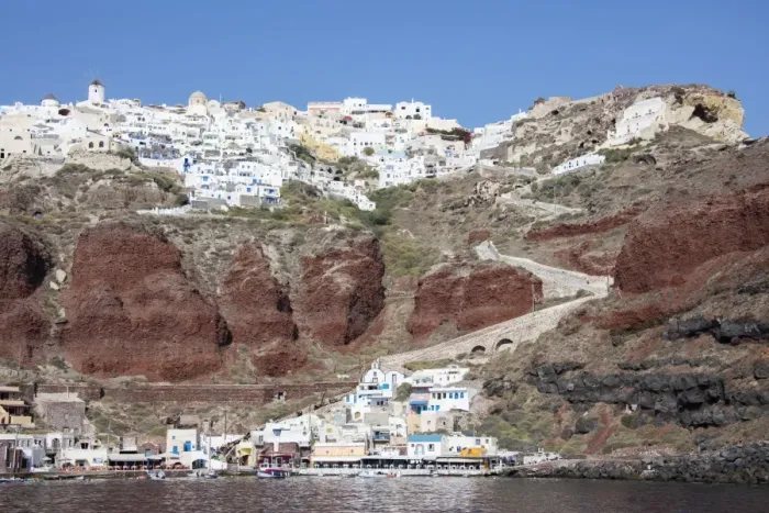 Framed Print : Typical Greek village perched on volcanic rock with white and blue houses and windmills Framed Print : Typical Greek village perched on volcanic rock with white and blue houses and windmills
