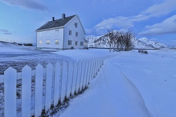 Typical house surrounded by snow at dusk, Flakstad, Lofoten Islands, Norway, Scandinavia