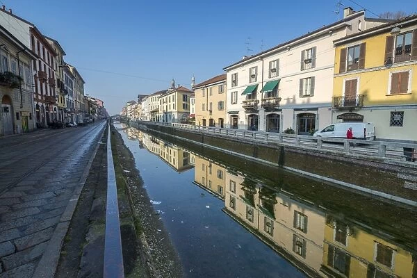 Typical houses reflected in the water of Naviglio Grande, Milan, Lombardy, Italy, Europe