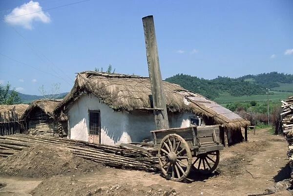 Typical rural house with straw roof in China, Asia