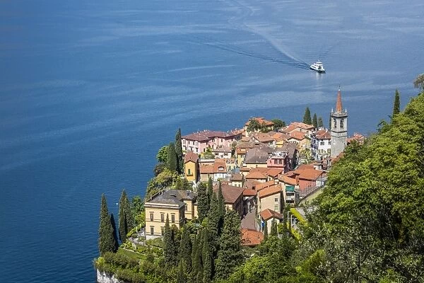 The typical village of Varenna surrounded by the blue water of Lake Como and gardens