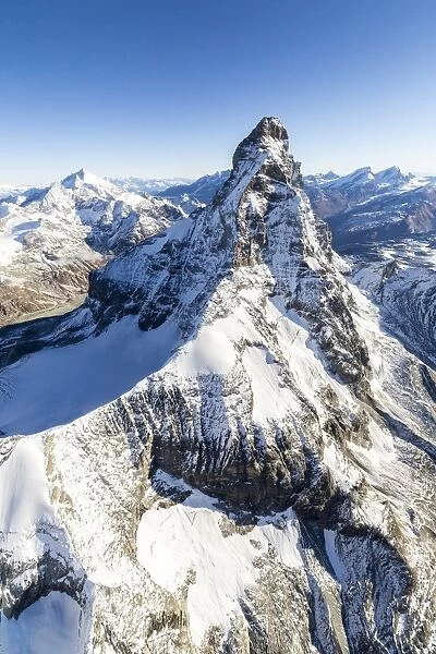 The unique shape of the Matterhorn sorrounded by its mountain range covered in snow, Swiss Canton of Valais, Swiss Alps, Switzerland, Europe