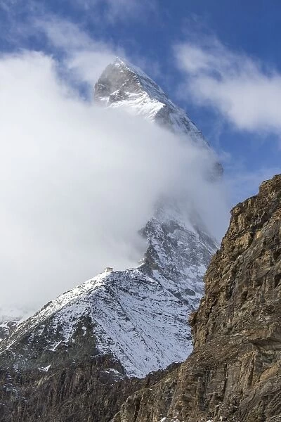 The unmistakable profile of the Matterhorn hidden by some fog, Swiss Canton of Valais, Swiss Alps, Switzerland, Europe