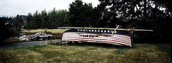 Upturned derelict boat with stars and stripes painted on hull, Washington state
