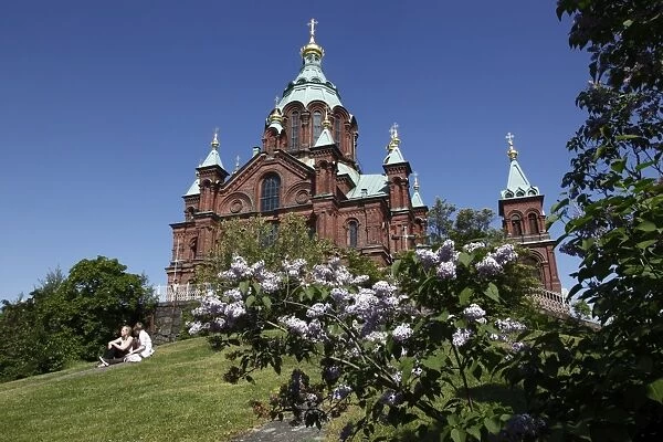 Uspenski Cathedral and girls sitting on hillside, Helsinki, Finland, Scandinavia, Europe