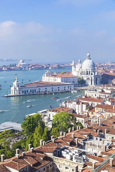 Vaporettos (water taxis), rooftops and the church of Santa Maria della Salute, on the Grand Canal