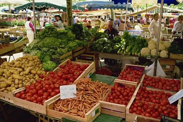 Vegetables including carrots, tomatoes and lettuce, for sale on market day at Euze