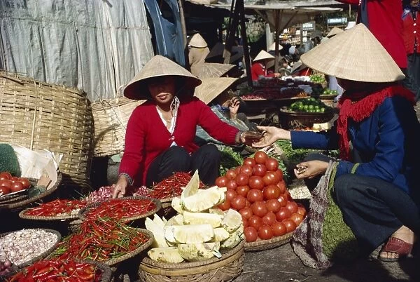 Vegetables and pineapples on sale in free market in southern Vietnam