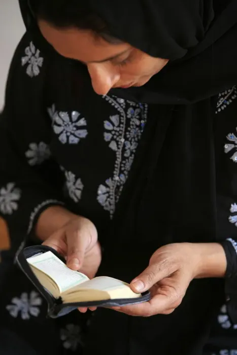 Framed Print : Veiled woman reading Koran, Montrouge, Hauts de Seine, France, Europe