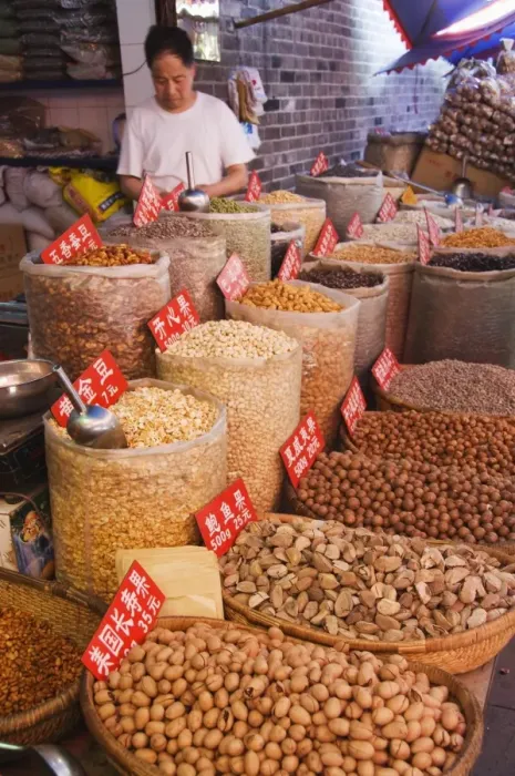 Framed Print : Vendor selling nuts at a market in the Muslim Quarter, home to the citys Hui community Framed Print : Vendor selling nuts at a market in the Muslim Quarter, home to the citys Hui community