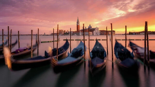 Venetian gondolas at sunset with the church of San Giorgio Maggiore in the background, Venice, UNESCO World Heritage Site, Veneto, Italy, Europe