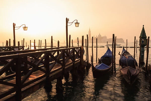 Venetian sunrise, winter fog, gondolas, San Giorgio Maggiore and Lido, Venice