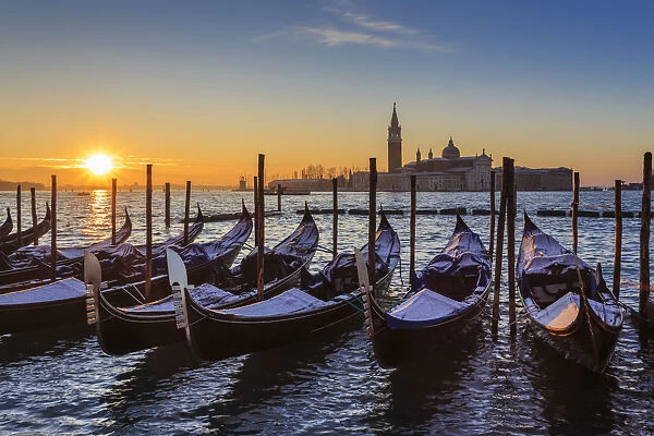 Venetian winter sunrise after snow with gondolas, San Giorgio Maggiore and Lido, Venice