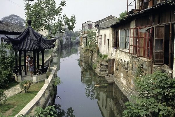 Venice of the East, one of the many canals still in use, lined with typical houses