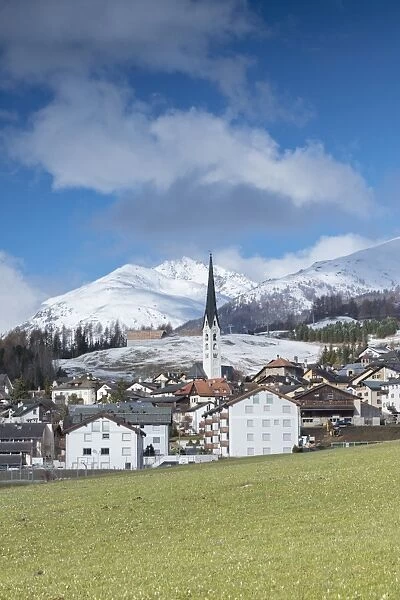 View of the alpine village of Zuoz surrounded by snowy peaks in spring, Maloja, Canton