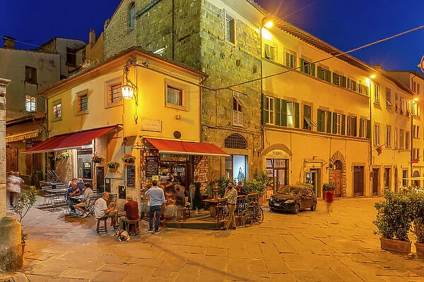 View of architecture and restaurant in narrow street at dusk, Arezzo, Province of Arezzo, Tuscany, Italy, Europe