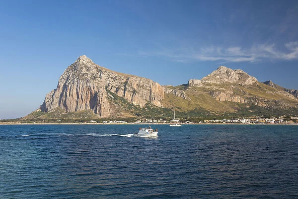 View across the bay to Monte Monaco and Pizzo di Sella, small boat returning to port