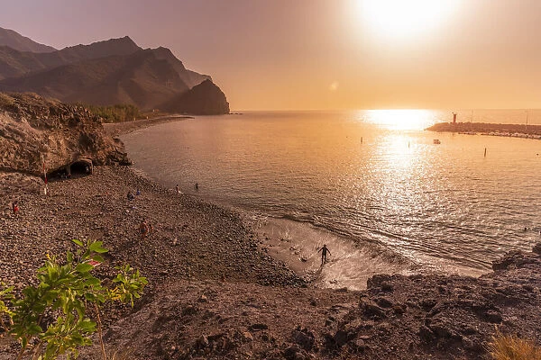 View of beach and coastline with mountains in background during golden hour, Puerto de La Aldea, Gran Canaria, Canary Islands, Spain, Atlantic, Europe