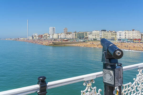 View of beach and telescope on a sunny day from Brighton Palace Pier, Brighton