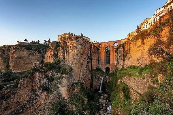View with beautiful bridge and waterfall and traditional white village, Ronda, Pueblos Blancos, Andalusia, Spain, Europe